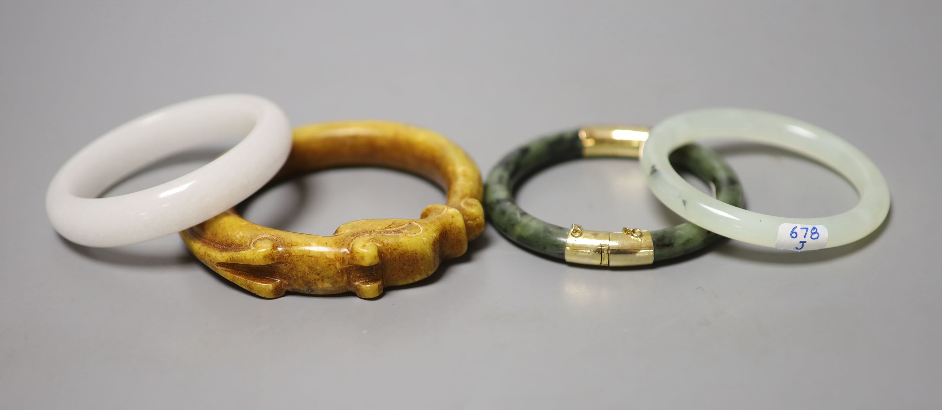 Four Chinese jade or hardstone bangles